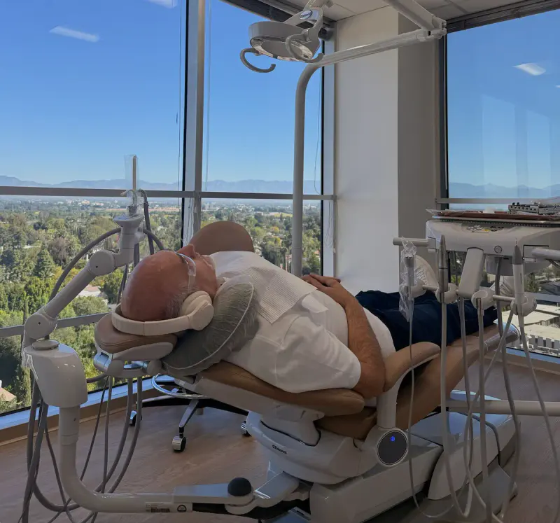Patient relaxing with noise-canceling headphones during dental care