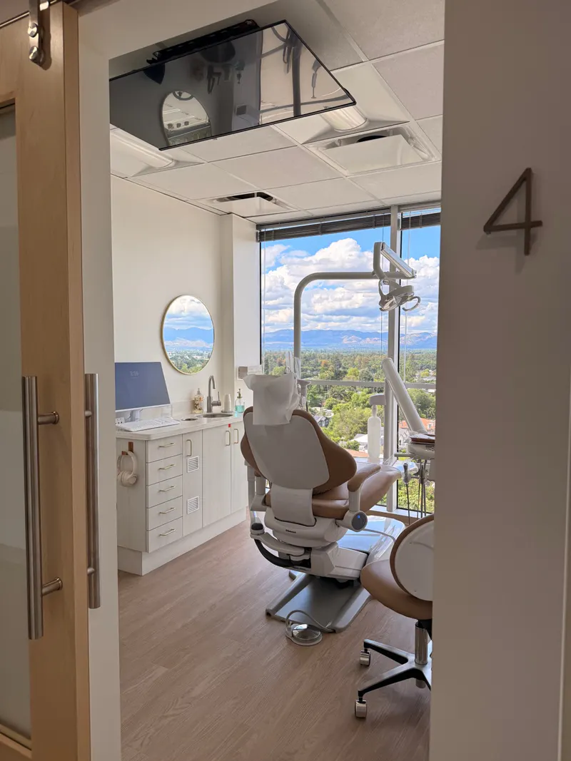 Bright treatment room with a dental chair and Valley view at My Dental Boutique in Encino